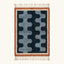 Full view of the Azul Beni Ourain rug with navy and blue abstract pattern, rust border and hand-tied fringe.