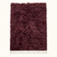Full view of burgundy Beni Ourain rug with thick textured pile and undyed ivory fringe