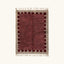 Full view of the Ziri burgundy and ivory Beni Ourain rug with a block border design.