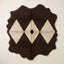 Flat view of Massa, a chocolate brown and ivory Beni Ourain rug with a diamond lattice motif and dark centre eye, irregular wavy edges, thick soft pile