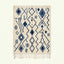 Ivory Azilal rug Imnayen with blue tribal diamonds, full rug view