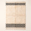 Ivory and Black Beni Ourain Rug with Checkerboard Border – Adrar, flat lay on plain background