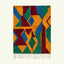 Full view of the Imazigh Boujaad rug in mustard, green, cobalt and burgundy with bold interlocking triangle forms
