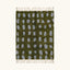 Full view of the Azil olive green and slate blue Beni Ourain rug with an oval grid design.