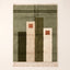 Olive, ivory and terracotta Mrirt rug with vertical colour blocks and small terracotta squares, flat lay on plain background