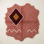 Rose, burgundy and gold Beni Ourain rug with central diamond medallion and cream zigzag border, irregular wavy edges