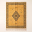 Saffron and charcoal Beni Ourain rug with concentric diamond motif, flat lay on plain background