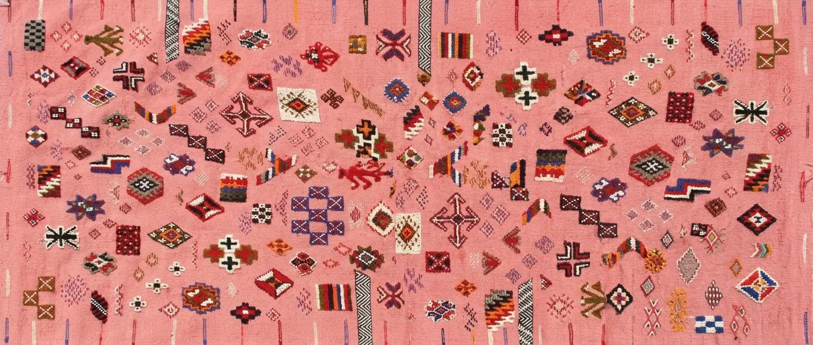 Handmade Moroccan wool rug with traditional tribal symbols