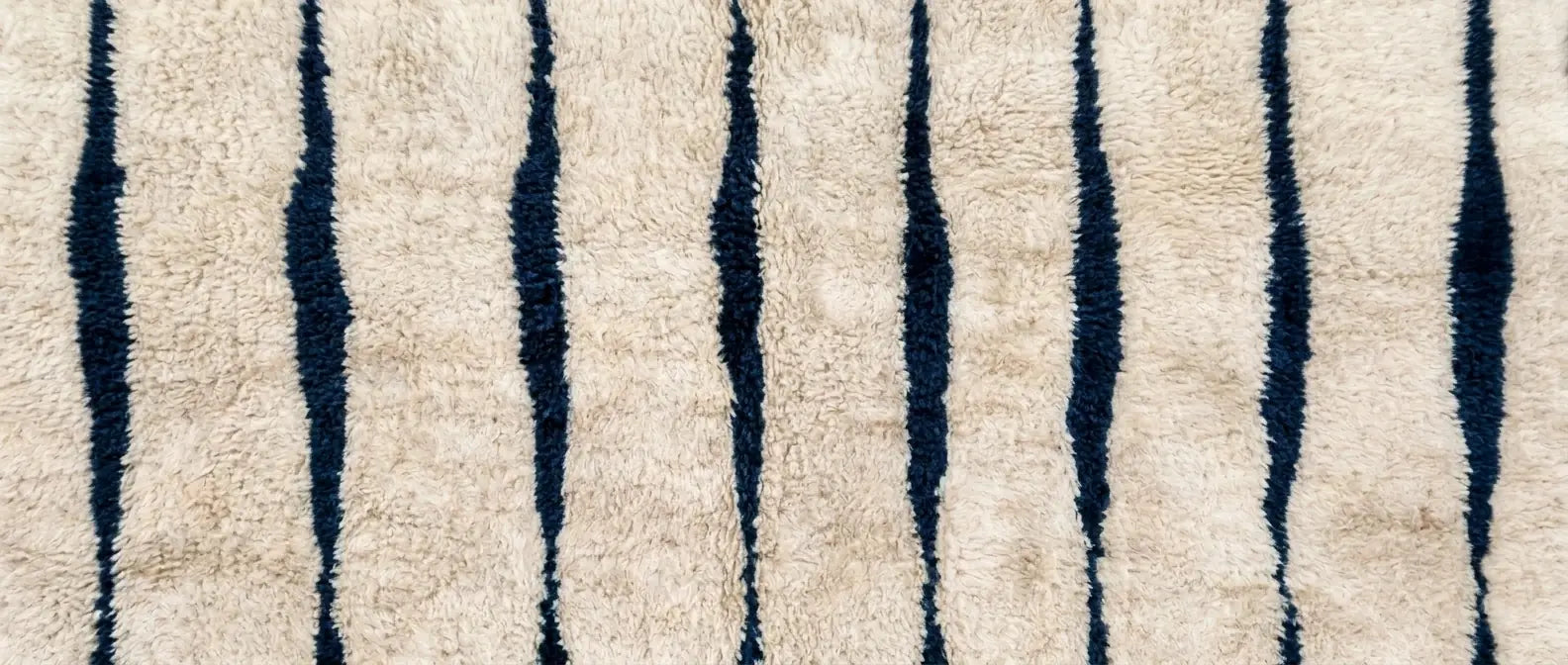 Handmade Moroccan wool rug with striped linear pattern