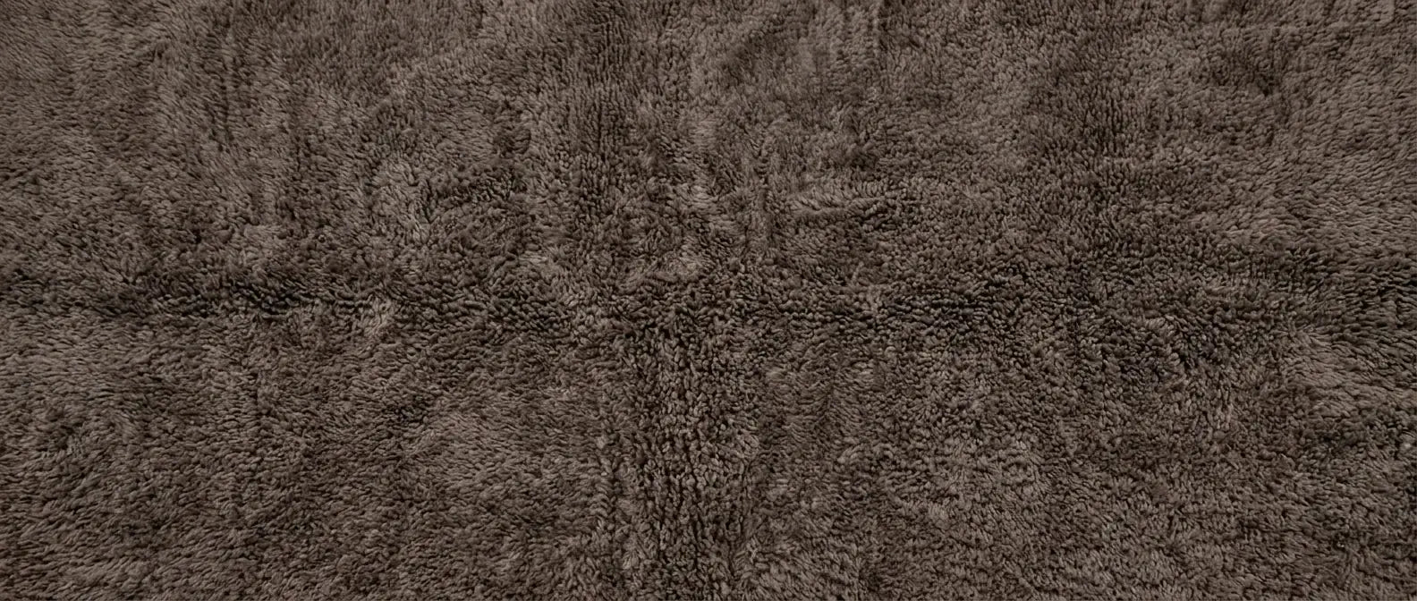 Handmade Moroccan wool rug with solid color and textured wool pile