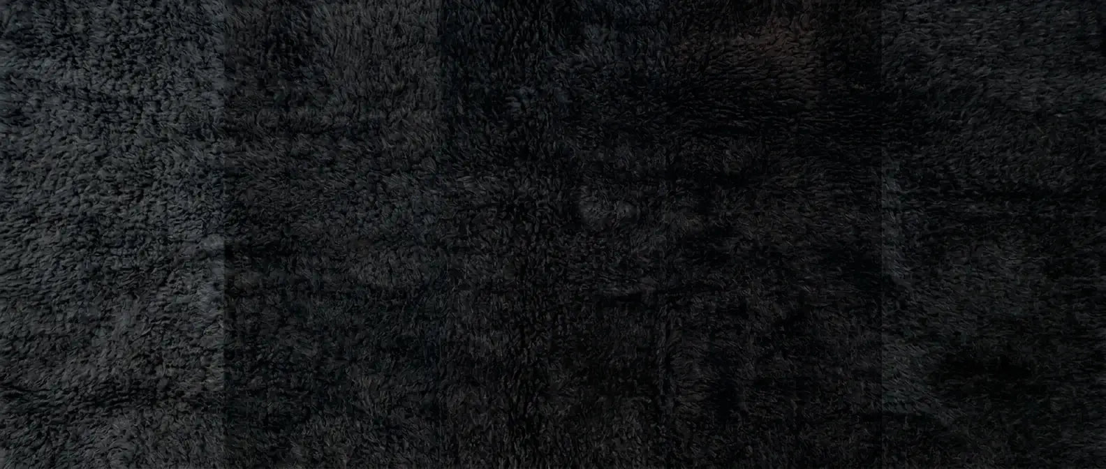 Handmade Moroccan wool rug in deep black and charcoal tones