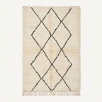 A rectangular cream-colored rug with a black diamond lattice pattern and fringe along the bottom edge, shown against a plain off-white background.