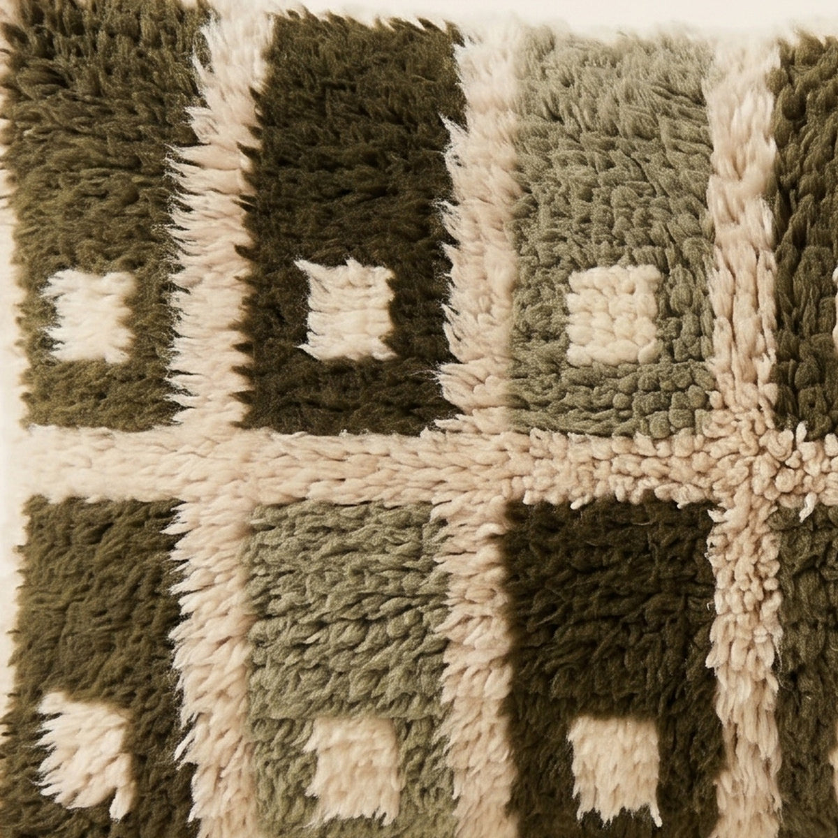 Detail of the shaggy wool pile and cream squares on the Afrag Moroccan pillow