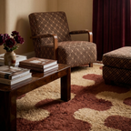 Aderfi terracotta and camel Beni Ourain rug styled beneath sculptural seating in a warm living room.