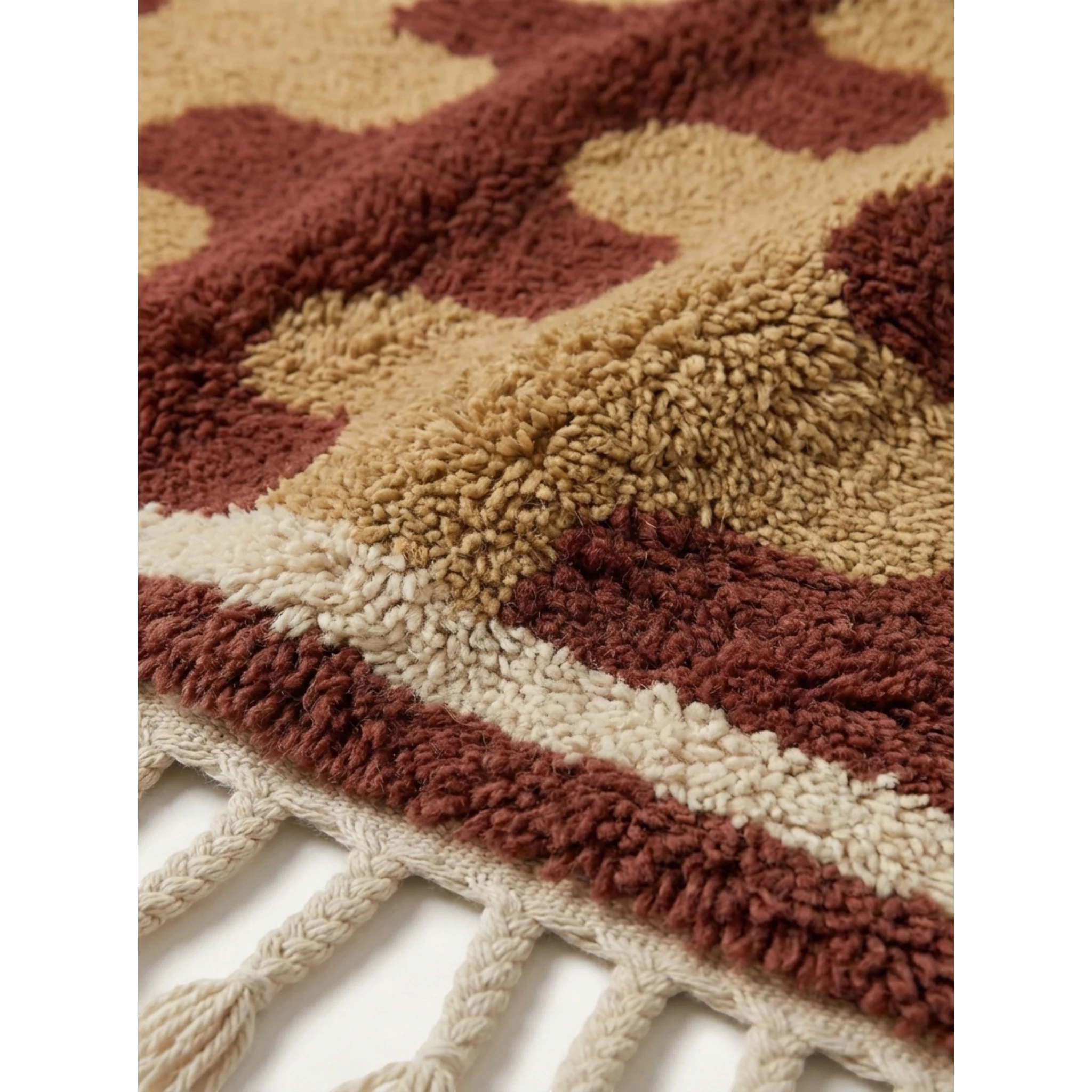 Close-up of the Aderfi rug's dense terracotta and camel wool pile.