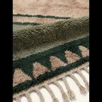 Hand-tied fringe and plush Atlas wool detail of the Agbalou olive rug.