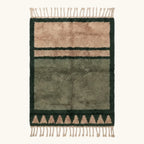 Full view of the Agbalou olive Beni Ourain rug with a framed triangle motif and hand-tied fringe.