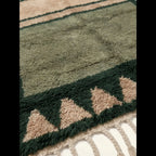 Dense olive and ivory wool texture detail of the Agbalou Moroccan rug.