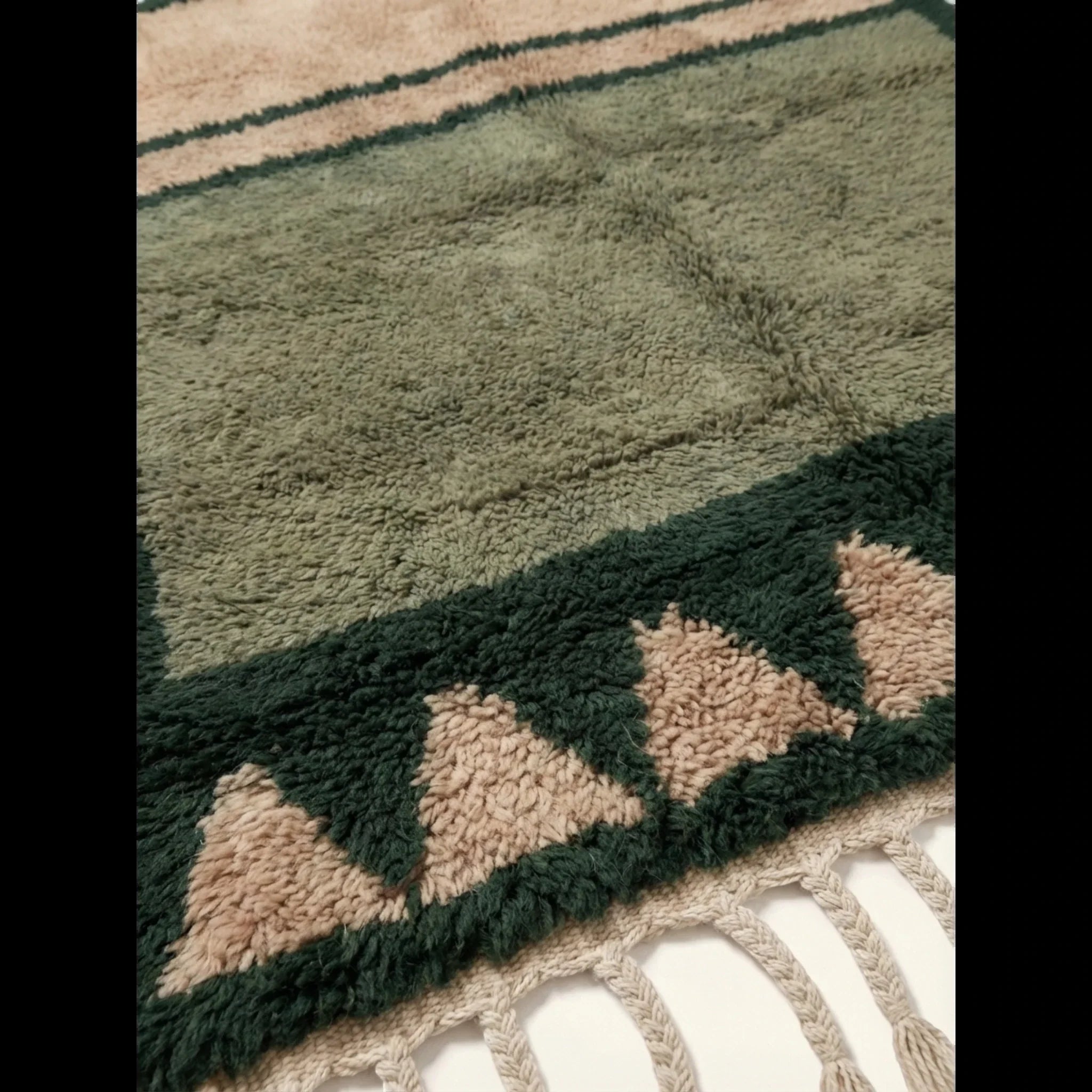 Dense olive and ivory wool texture detail of the Agbalou Moroccan rug.