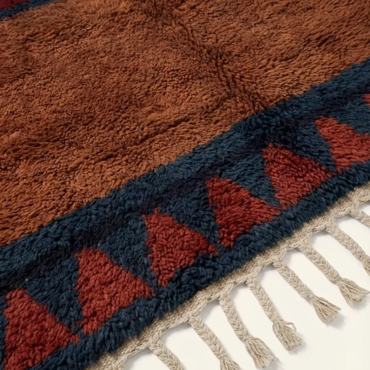 Aksel rust and navy Beni Ourain rug hand-knotted fringe detail