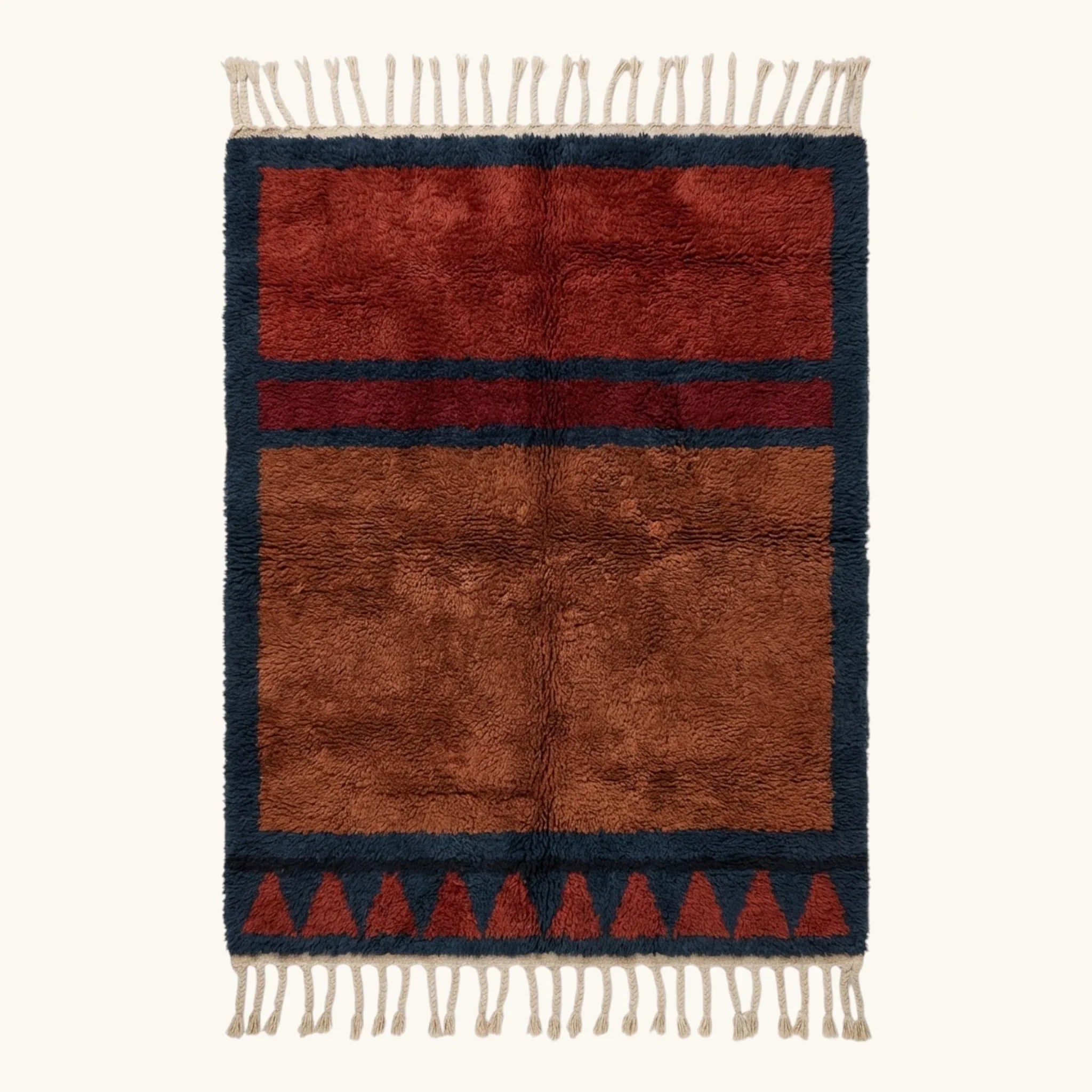 Full view of the Aksel rust Beni Ourain rug with a navy framed triangle motif and hand-tied fringe.