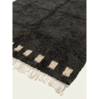Hand-tied fringe and plush wool detail of the Amanar charcoal rug.