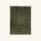 Full view of the Amnay green Beni Ourain rug with small ivory cross motifs.