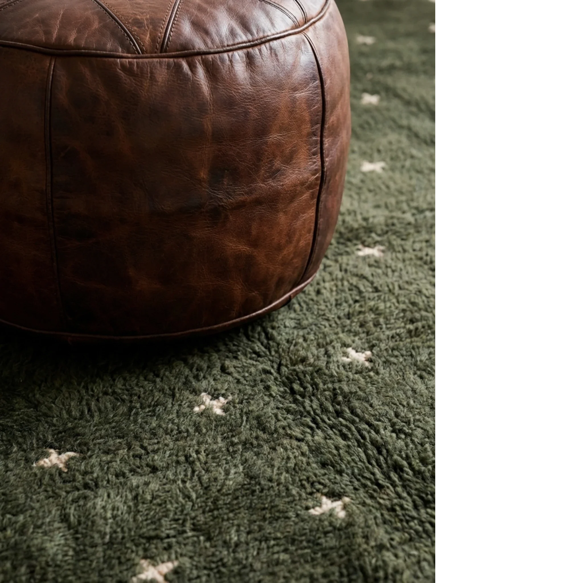 Amnay green Beni Ourain rug styled beside a sculptural leather chair.