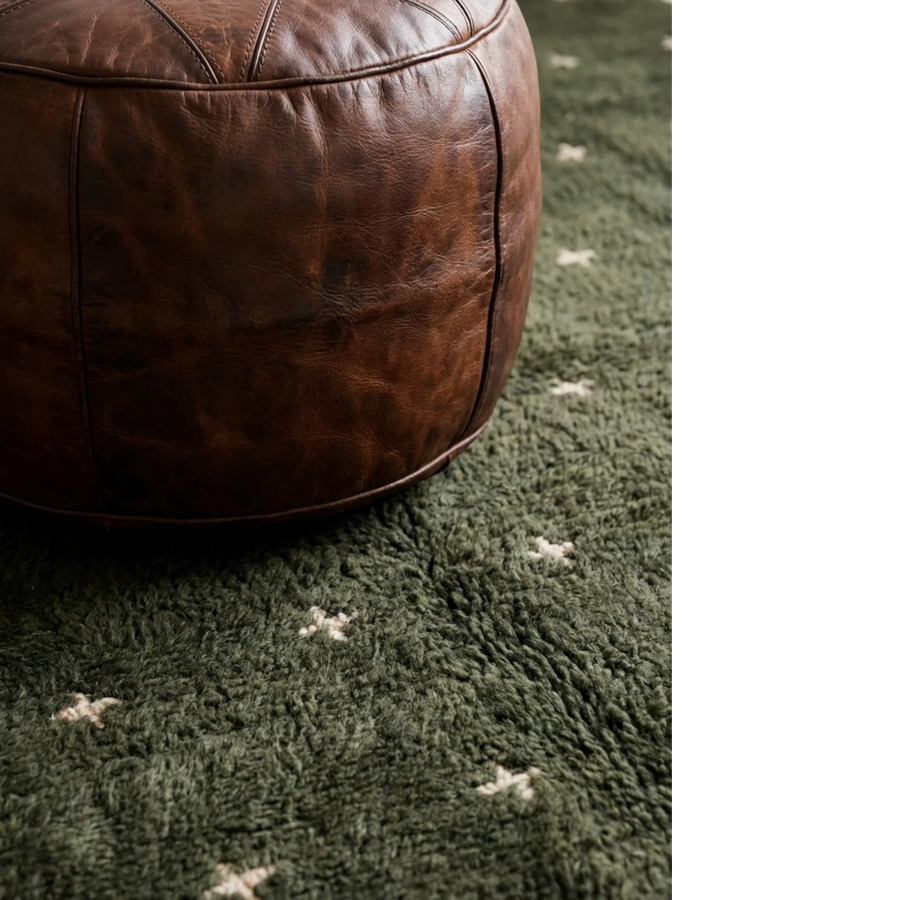 Amnay green Beni Ourain rug styled beside a sculptural leather chair.