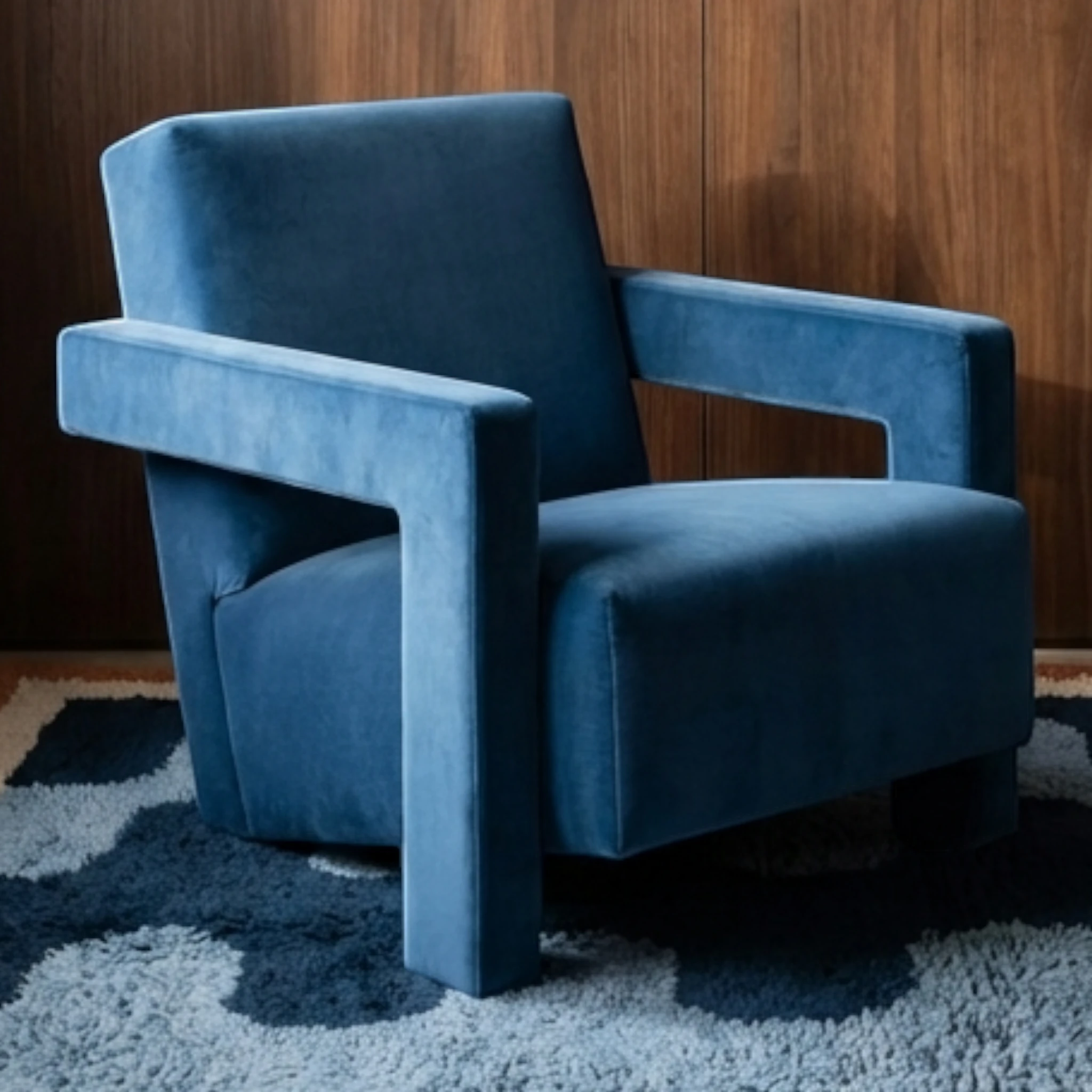 Azul navy blue Beni Ourain rug styled beneath a sculptural blue armchair.