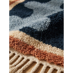 Close-up of the Azul rug's dense hand-knotted navy and blue wool pile beside the fringe.