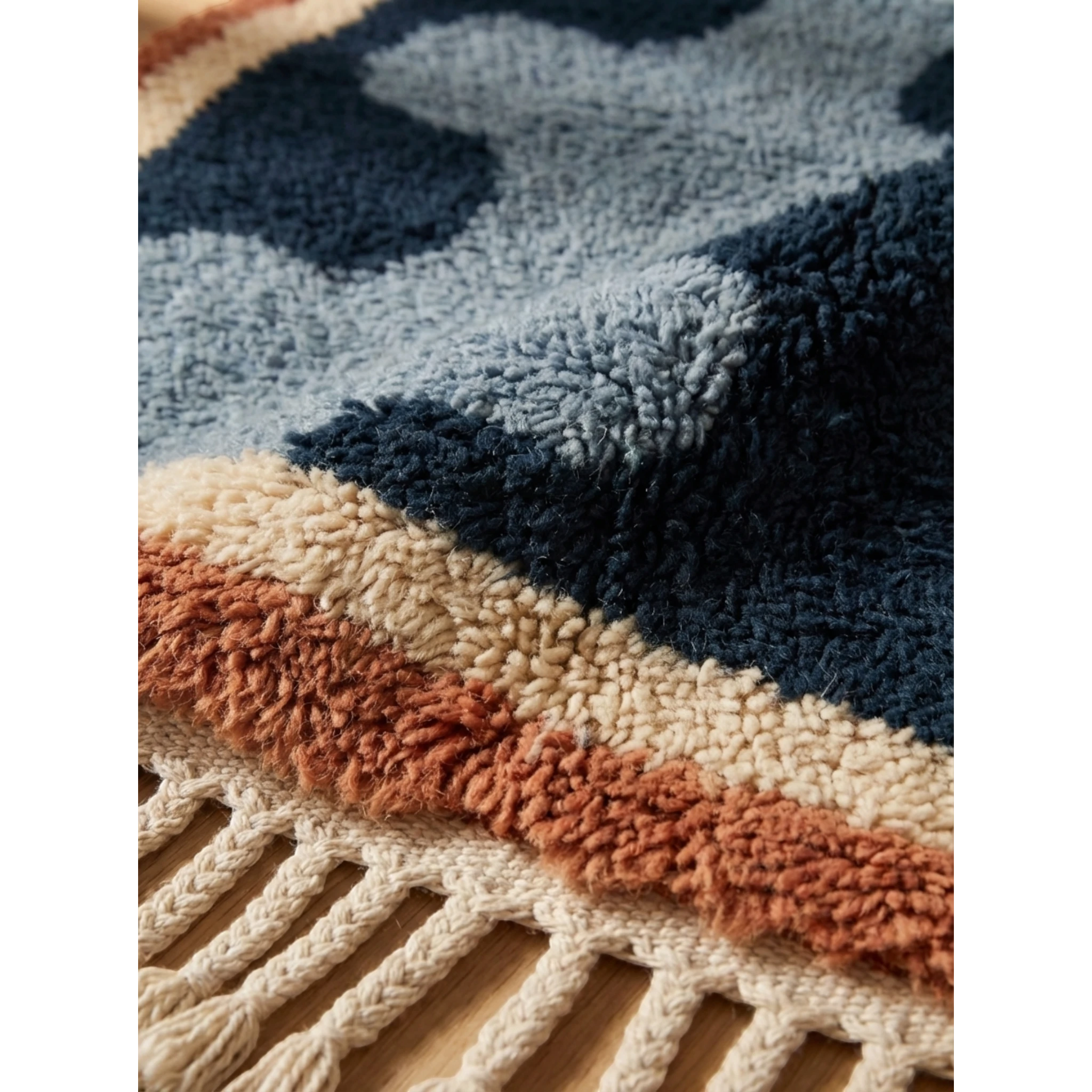 Close-up of the Azul rug's dense hand-knotted navy and blue wool pile beside the fringe.