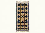 Beige and navy Mrirt runner with three columns of dark navy oval pebbles on a plain background, Tafukt design