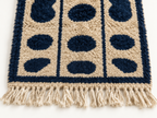 Close-up of beige and navy Mrirt runner showing dense soft pile and navy oval pebbles, Tafukt