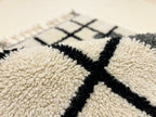 Macro detail of Tilelli runner showing handwoven wool knots and charcoal grey accents