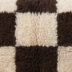 Close-up of the checkerboard pattern on the Izem Moroccan wool pillow
