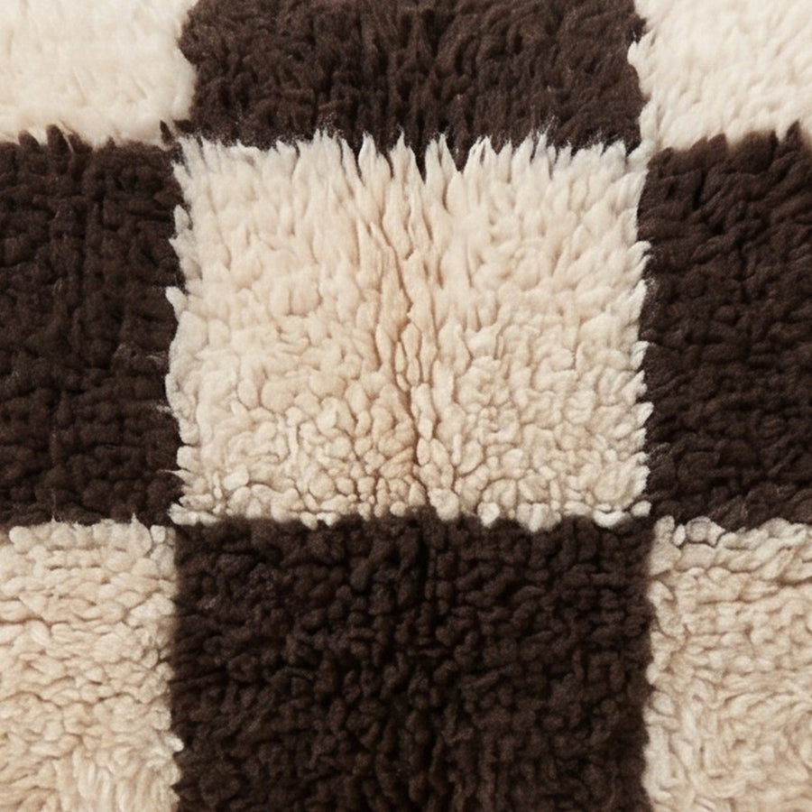 Close-up of the checkerboard pattern on the Izem Moroccan wool pillow