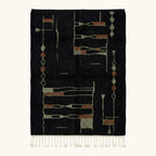 Full view of the Aghbal black, terracotta and olive Beni Ourain rug with an abstract linear design.