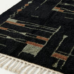 Close-up of the abstract linear pattern on the Aghbal rug.