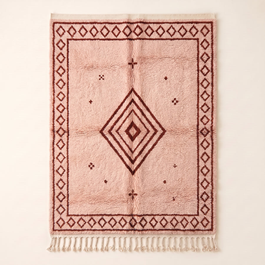 Full flat view of Blush & Rust Beni Ourain Damya rug with concentric diamond motif and bordered design