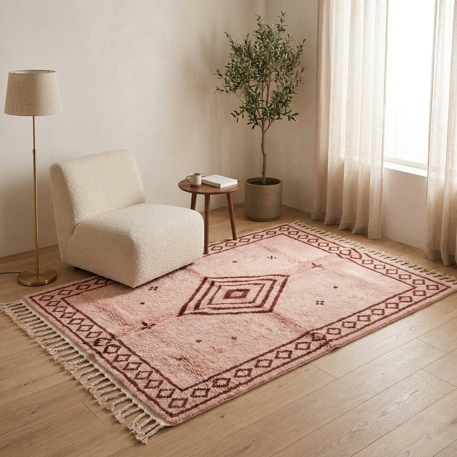 Blush & Rust Beni Ourain rug in modern living room with cream chair and side table