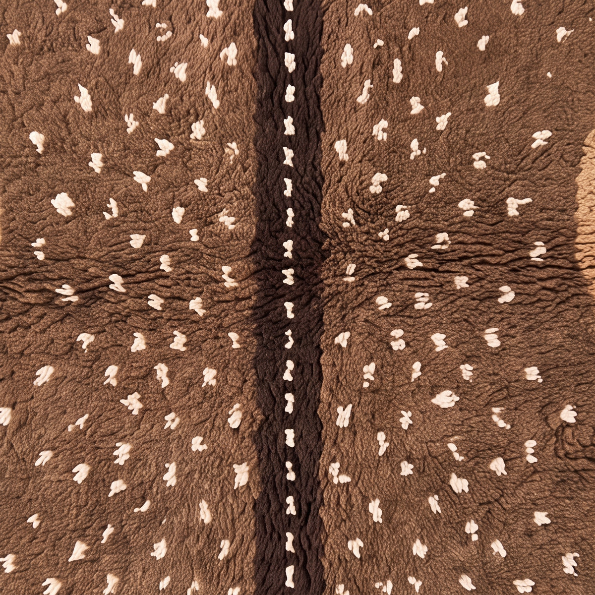 Central dark line dividing speckled stripes with cream fringe at base of Fawn rug