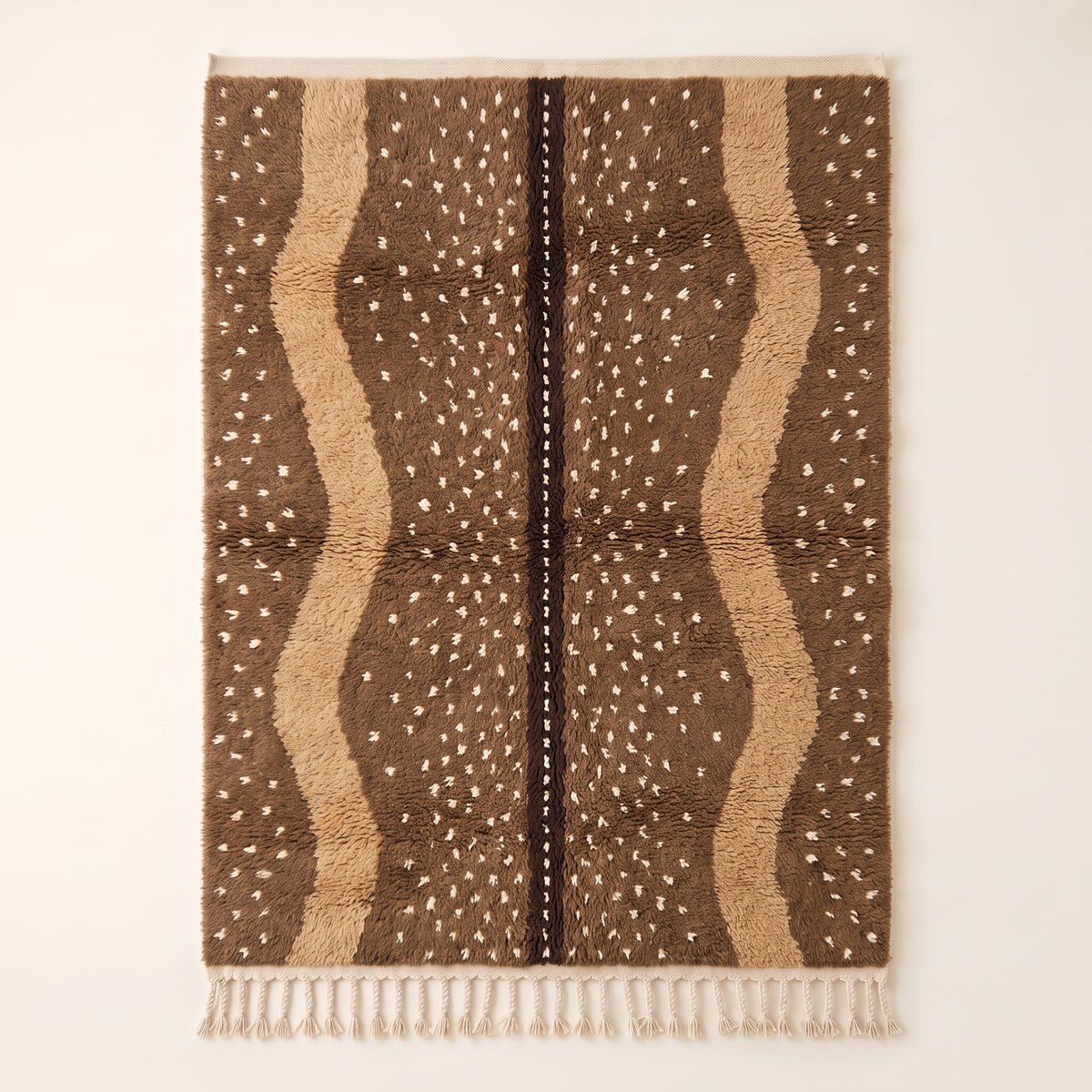 Fawn Beni Ourain rug with brown and ivory vertical speckled stripes and dark central line, flat view