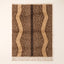 Fawn Beni Ourain rug with brown and ivory vertical speckled stripes and dark central line, flat view