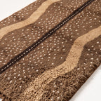 Close-up of speckled stripe pattern and thick wool pile texture on Fawn rug