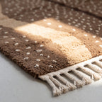 Macro view of soft hand-knotted wool pile and white fleck pattern on brown stripe