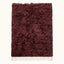 Burgundy Beni Ourain rug Tafat with thick textured pile and ivory fringe, flat lay