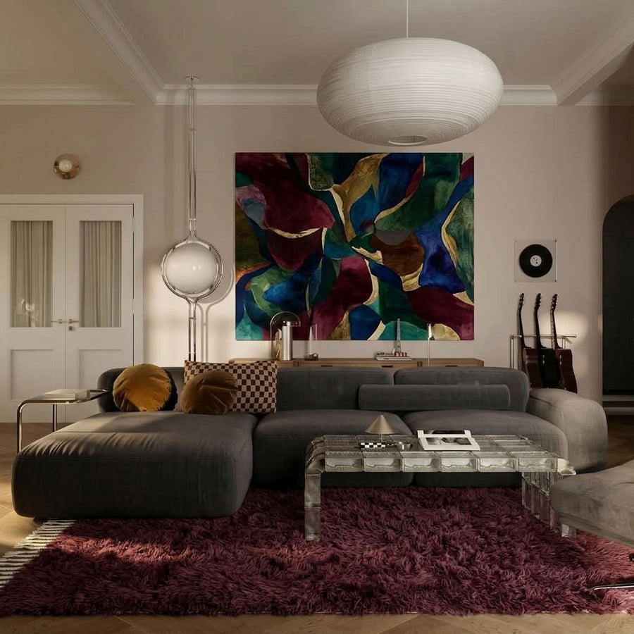 Burgundy Beni Ourain rug placed in modern living room with grey curved sofa and pendant lighting
