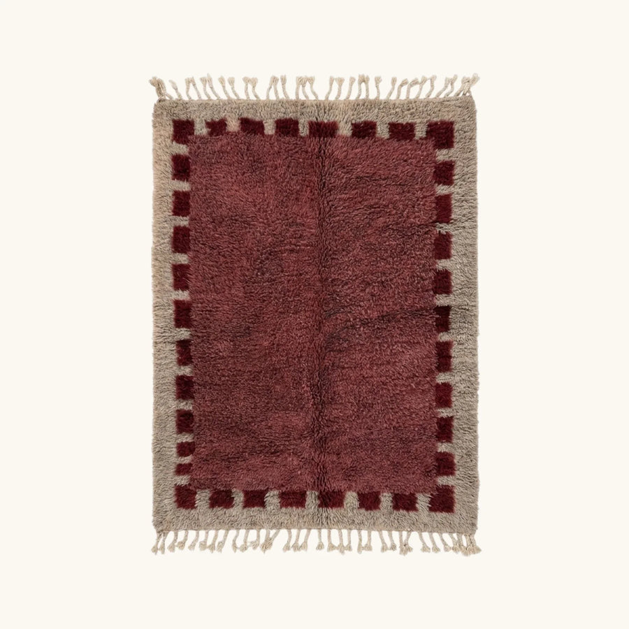 Full view of the Ziri burgundy and ivory Beni Ourain rug with a block border design.