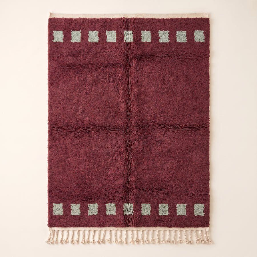 Burgundy Beni Ourain rug with mint green stacked squares in bands at top and bottom, full flat view